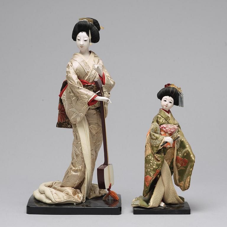 Two Japanese dolls and a box with minitures, 20th Century.