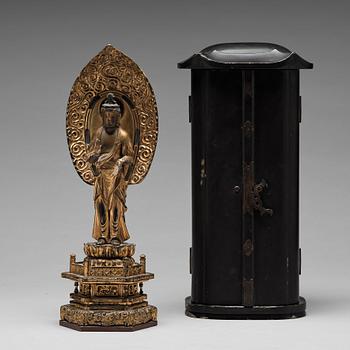 A Japanese gilt and lacquered wooden figure of Buddha and a travel shrine, Edo Period, 19th century.