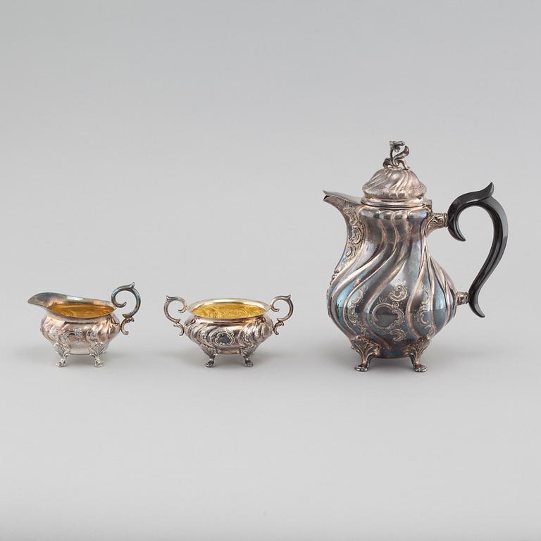 A silver rococo style coffee pot, sugar bowl and creamer from GAB and C G Hallberg in Stockholm, 1950s/60s.