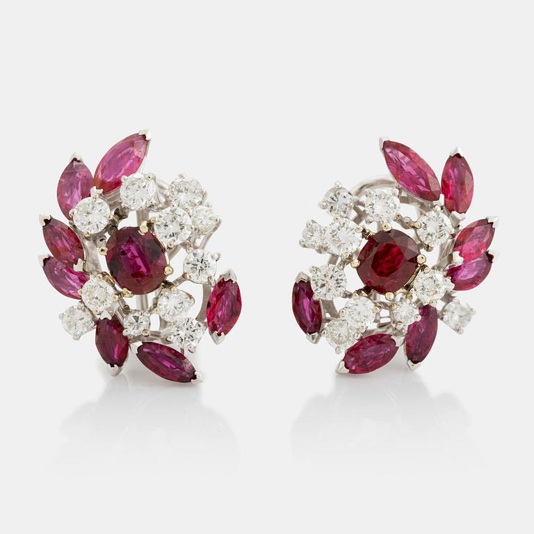 A pair of 18K white gold earrings set with faceted rubies and round brilliant-cut diamonds.