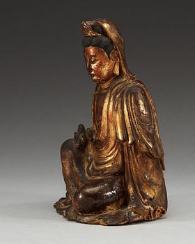 A gilt lacquer and wooden sitting figure of Guanyin, Ming dynasty (1368-1644).