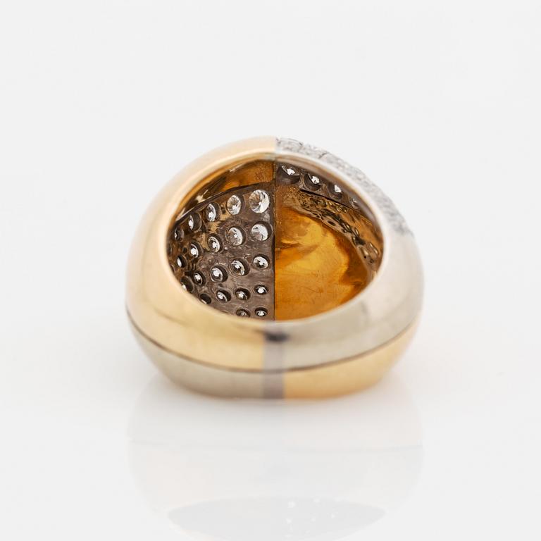 A Paul Binder ring in 18K gold set with round brilliant-cut diamonds.