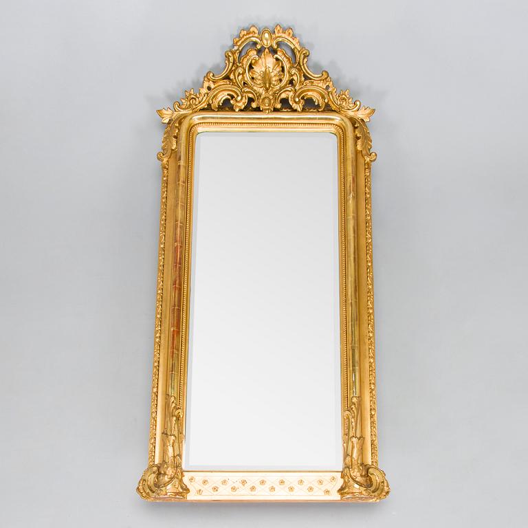 A Rococo Revival style mirror, circa 1900.