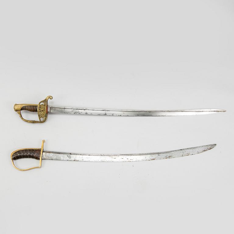 An end of the 18th Century Swedish sabre and a 19th century French century sabre, both with scabbards.