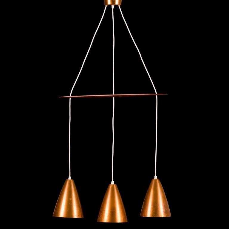 A 1960s three-shade copper and wood pendant ceiling light.