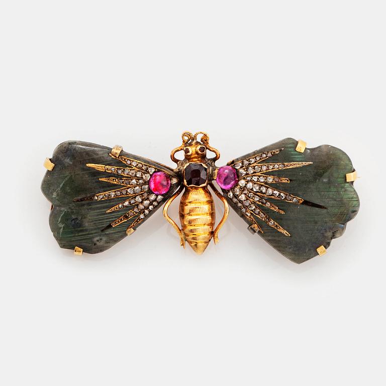 A butterfly brooch in 14K gold set with labradorite, rubies, rose-cut diamonds and garnets.