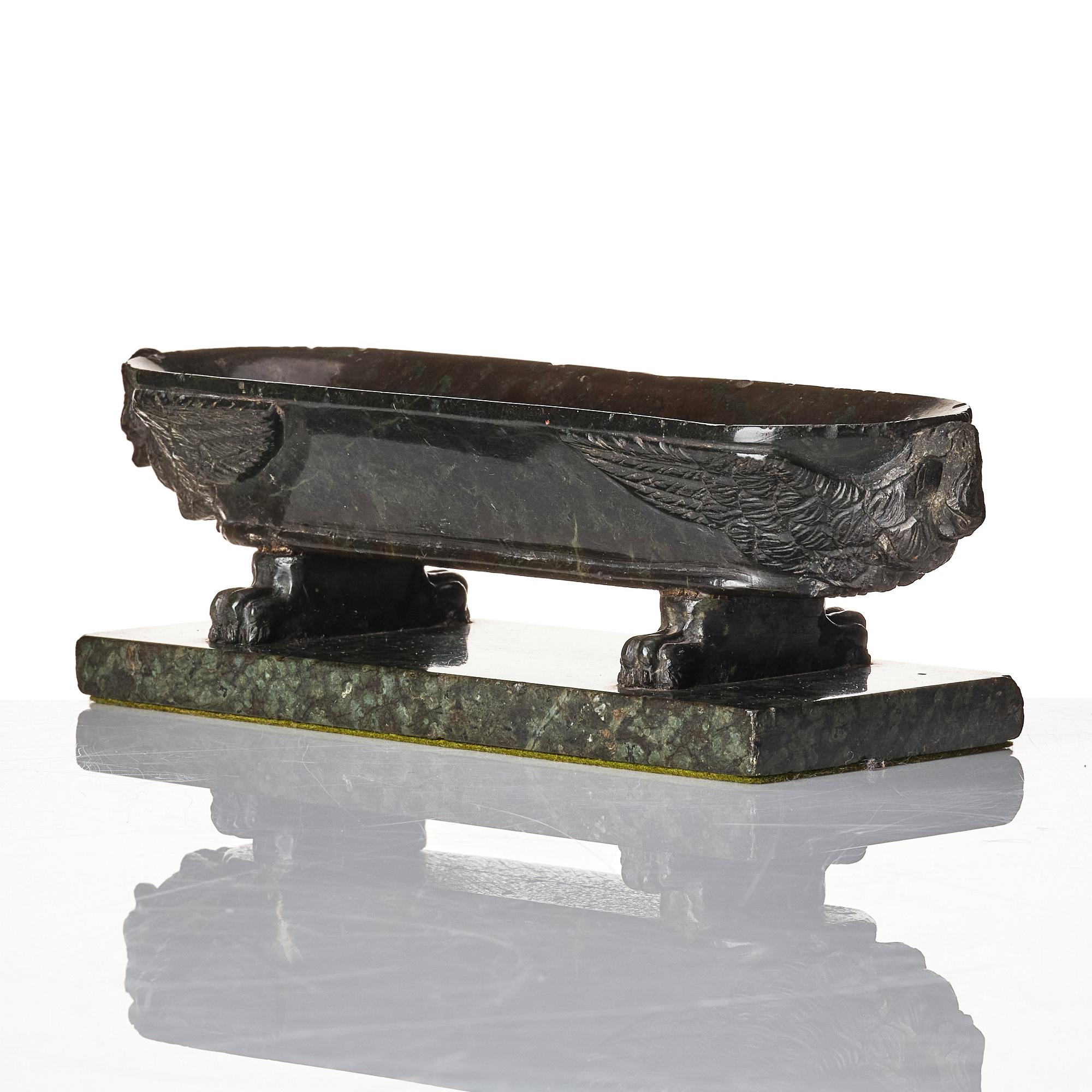 A stone sarcophagus shaped bowl late 19th century.
