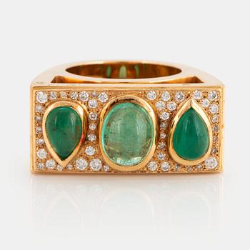 1055. An 18K gold ring set with cabochon-cut emeralds and round brilliant-cut diamonds.