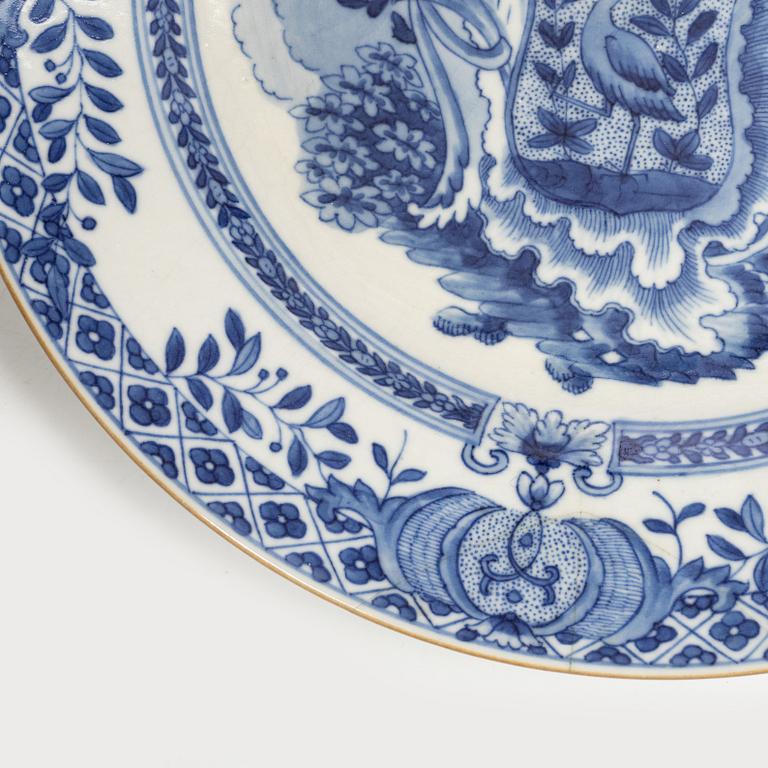 A pair of armorial dinner plates, soft paste, Qing dynasty, 18th century.