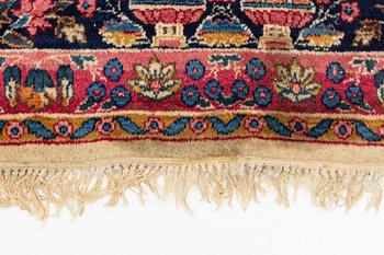 An carpet, possibly Kirman, signed, 350 x 255 cm.