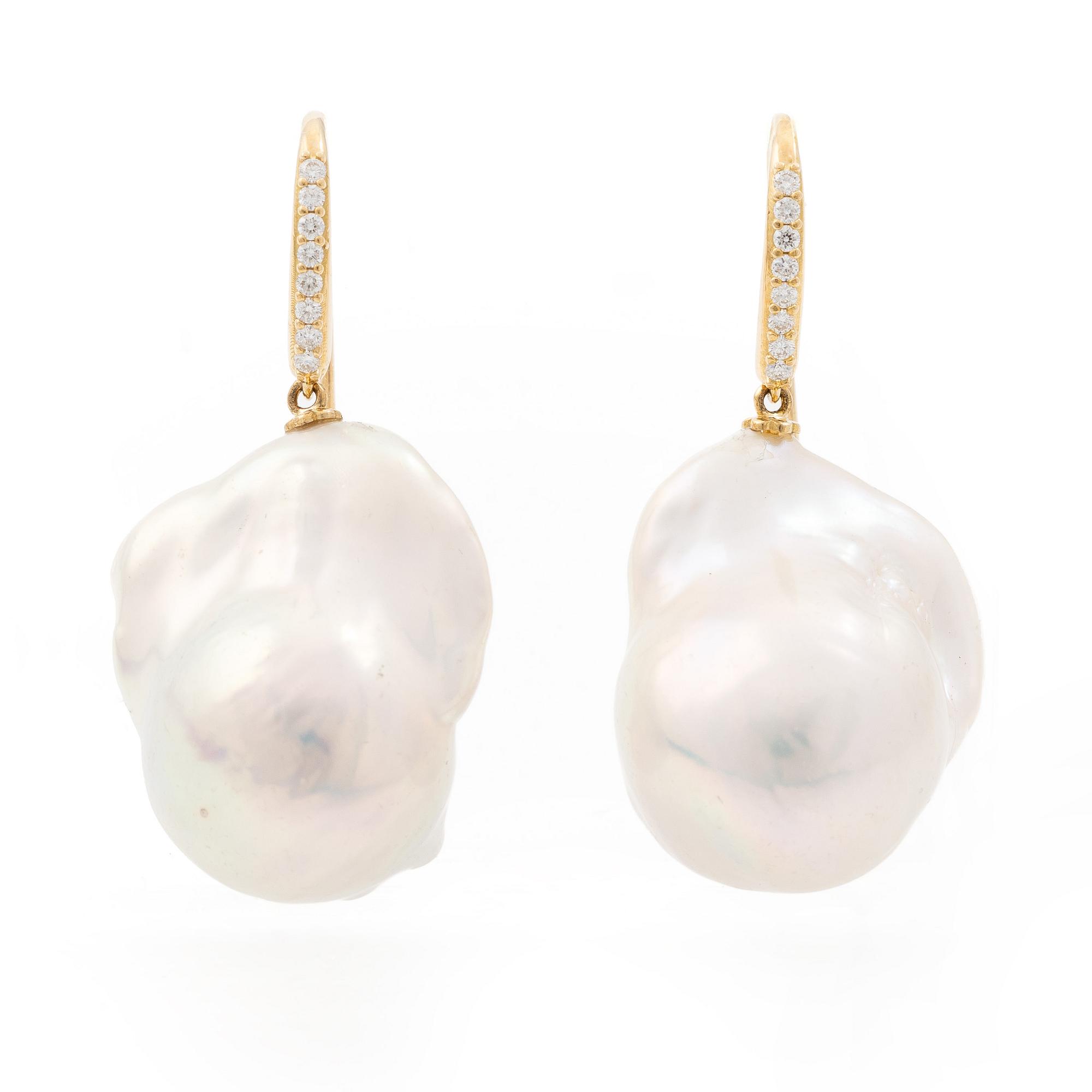 A pair of earrings with cultured baroque-shaped freshwater pearls and round brilliant-cut diamonds.