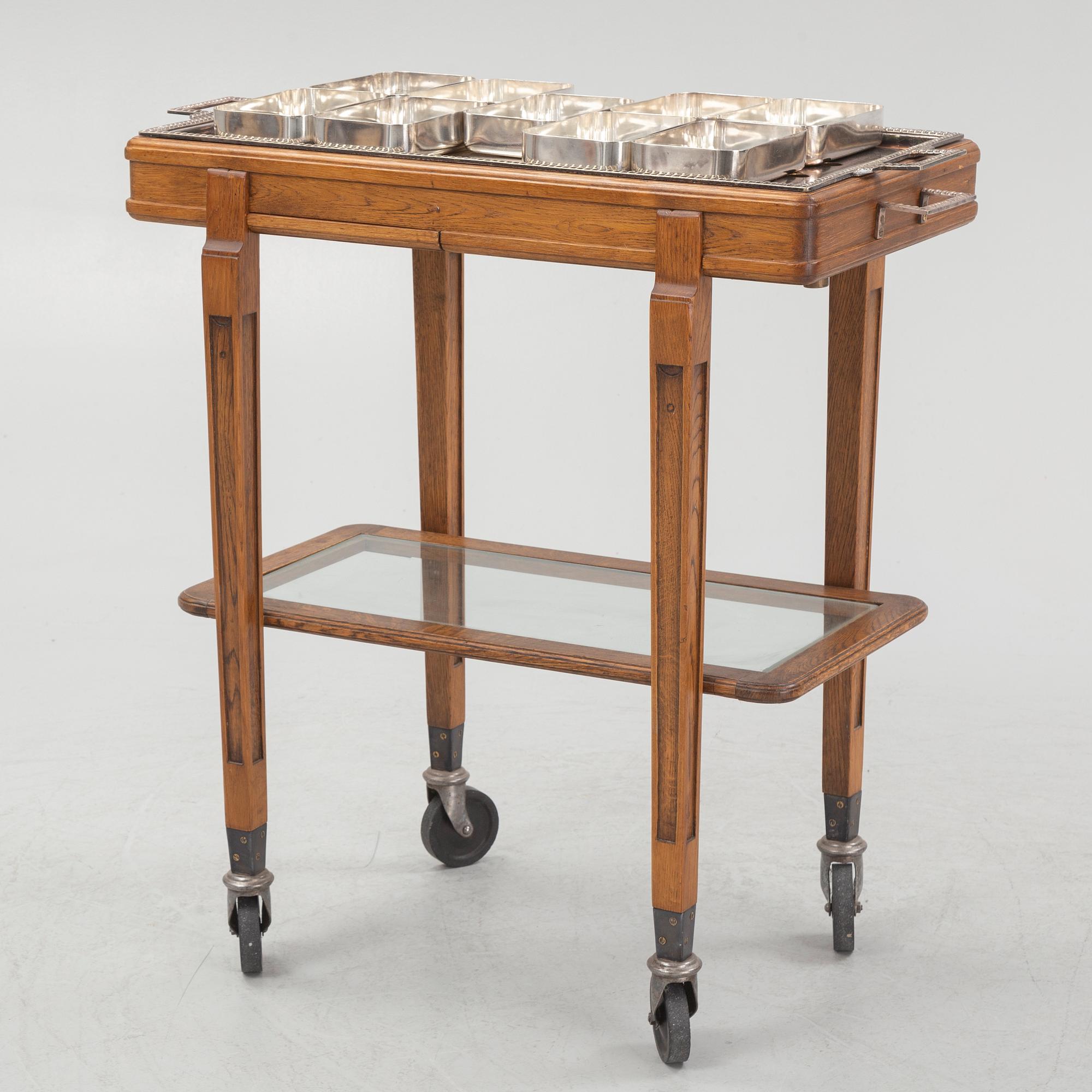 A restaurant serving trolley with silver plate dishes, first half of the/mid 20th century.