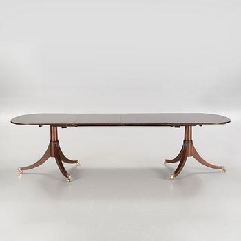 An english style dining table and eight chairs, second half of the 20th century.