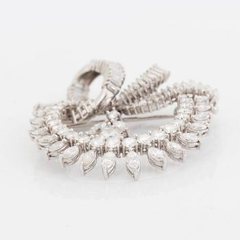 A platinum brooch set with navette-, tapered baguette- and brilliant-cut diamonds.