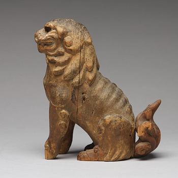 A wooden sculpture of a buddhist lion, Qing dynasty, 19th Century.