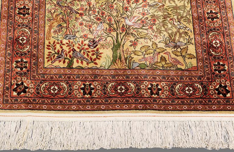 An Oriental figural silk rug, ca 126 x 83 cm.