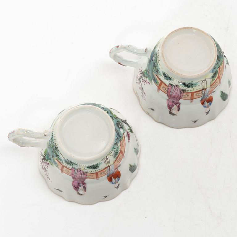 A pair of Chinese famille rose teacups with saucers and a pair of plates and two dishes, Qing dynasty, 18th century.