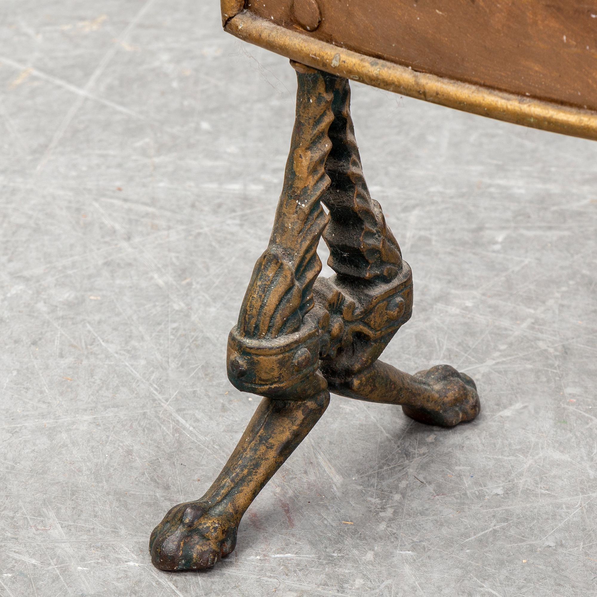 A 19th century brass fire shield decorated with paint of hunting dog setter in the stable.