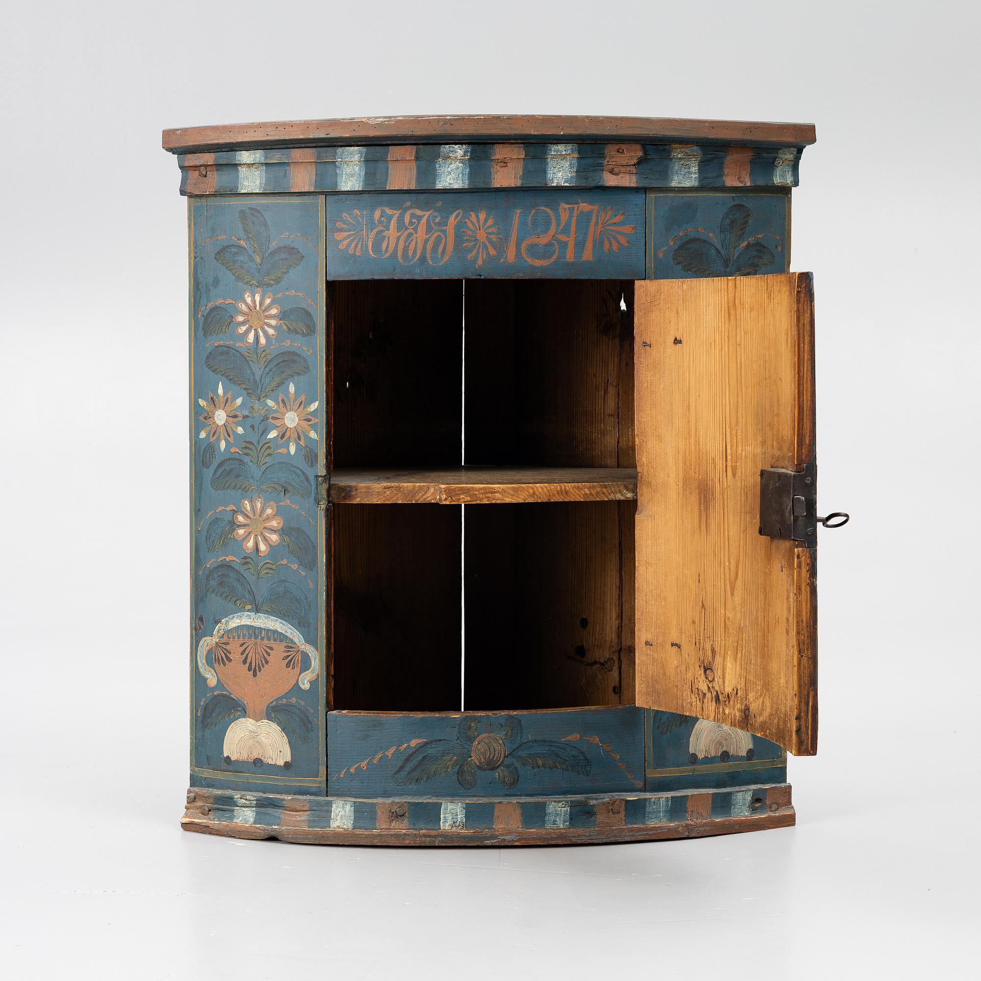 A folk art corner cabinet from Delsbo, Hälsingland dated 1847.