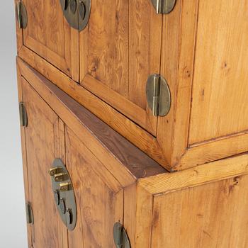 A Chinese hardwood two-part cabinet, 20th century.