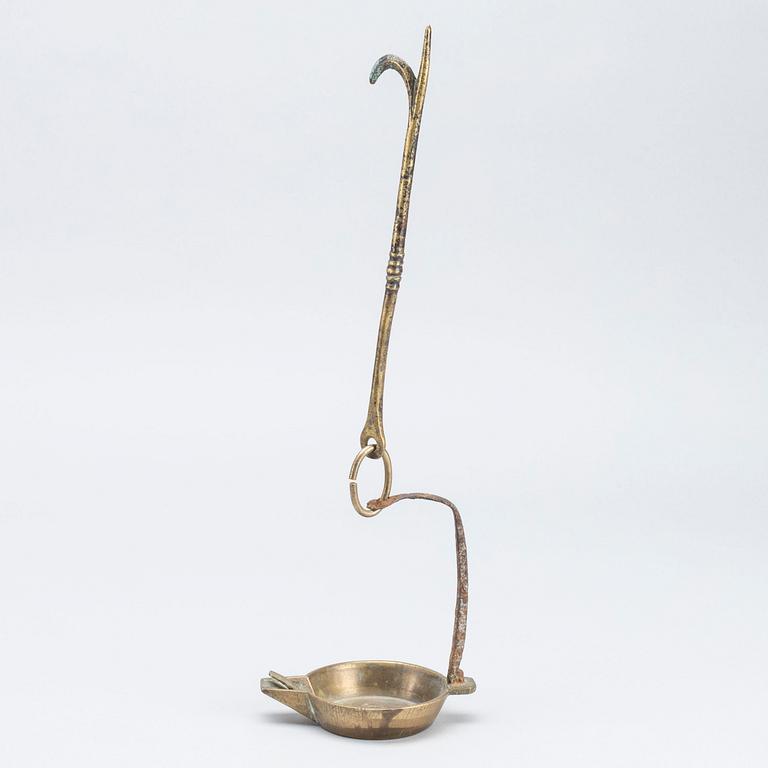 A 18th century oil lamp.