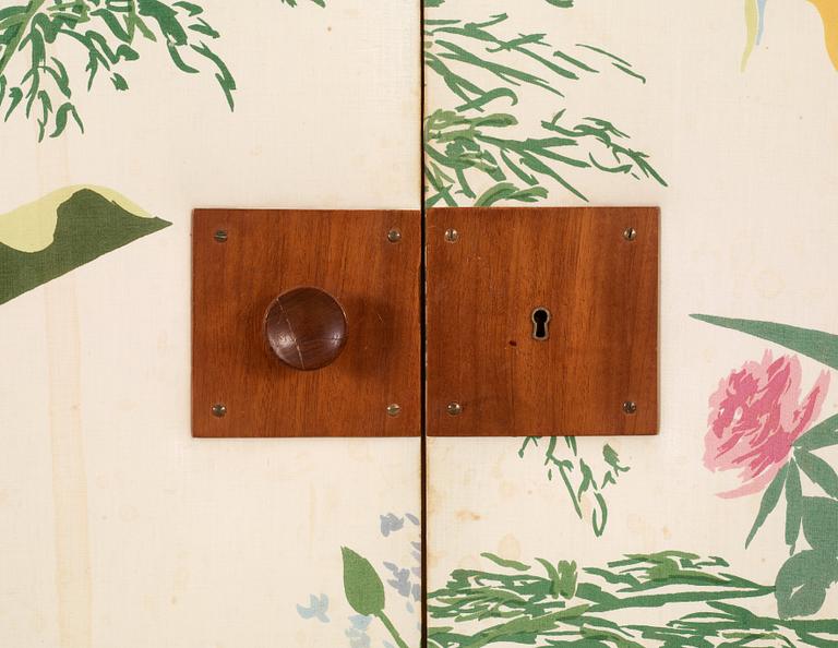 A Josef Frank mahogany cabinet, the doors and sides upholstered with floral chintz fabric, Svenskt Tenn 1940's-50's.