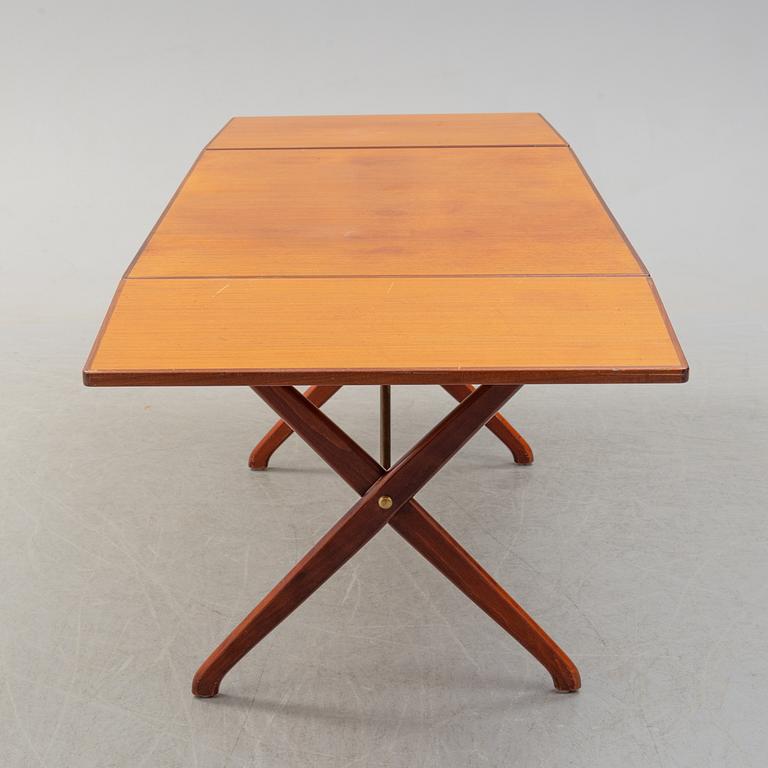A teak veneer and stained beech dining table, mid 20th Century.