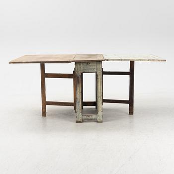 A 18th century gate-legged pine table.