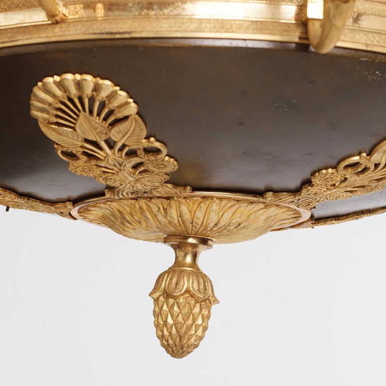 An Empire.style five-branch patinated and gilt bronze chandelier, later part of the 19th century.