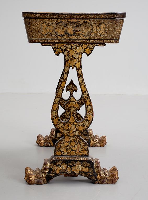 A gold and black lacquer sewing table, Qing dynasty, ca 1800.