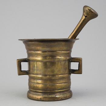 A 18th century brass mortar with pestle.