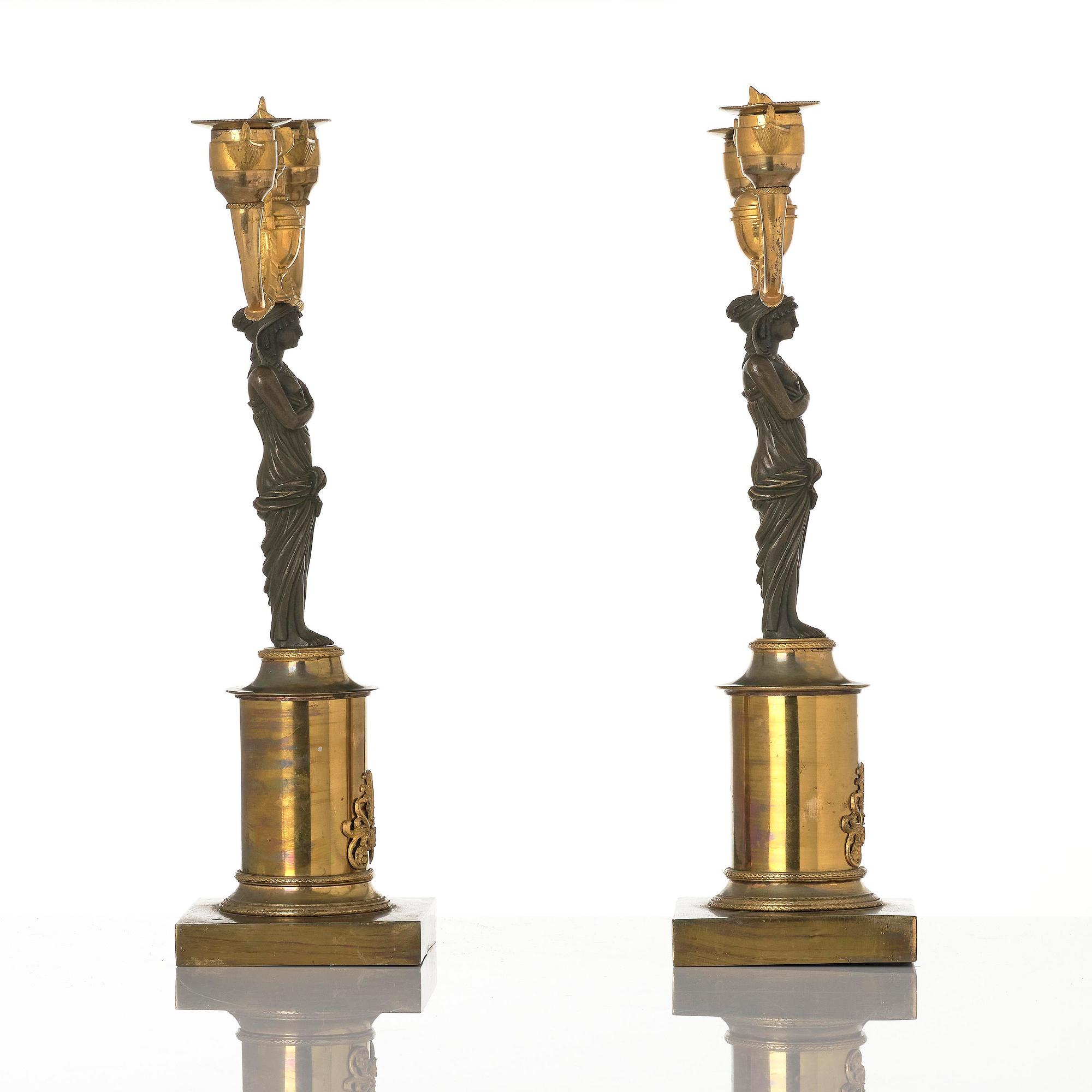 A pair of Swedish Empire ormolu and patinated two-branch candelabra, Stockholm, early 19th century.