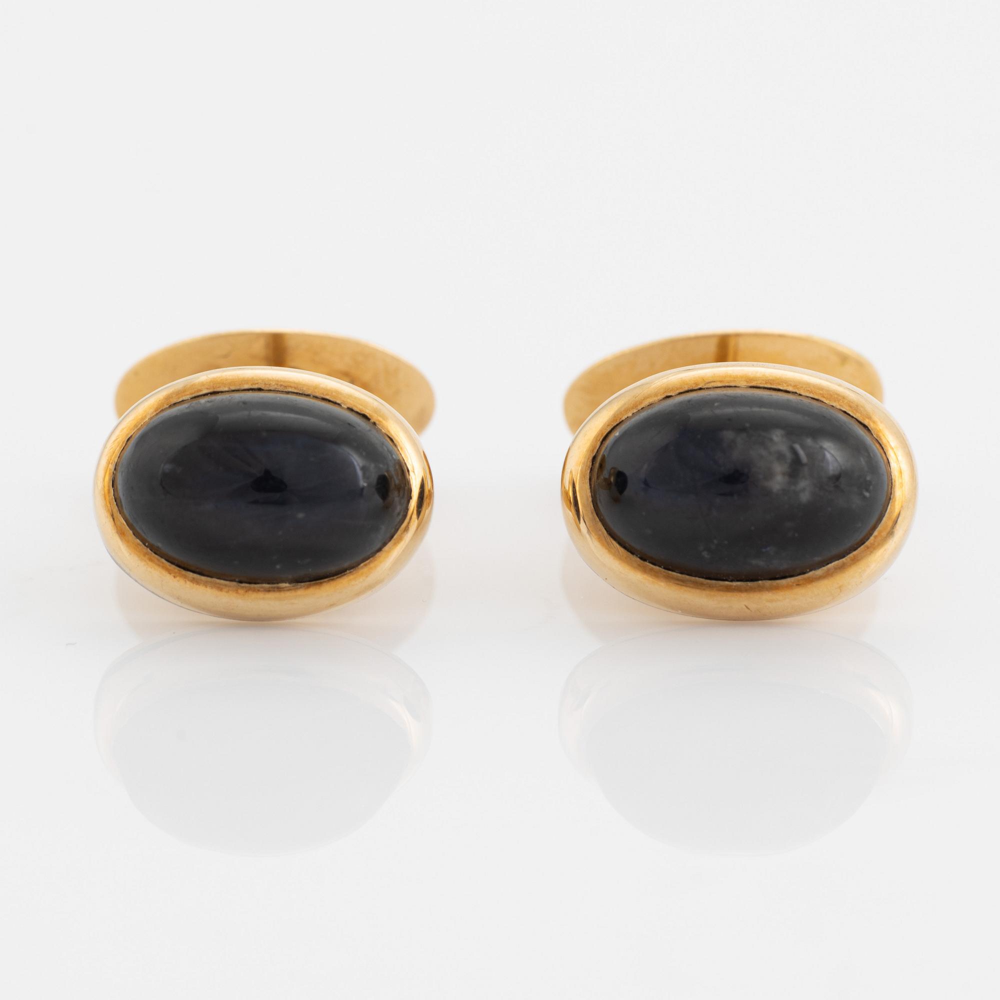 18K gold and cabochon cut blue stone cufflinks.