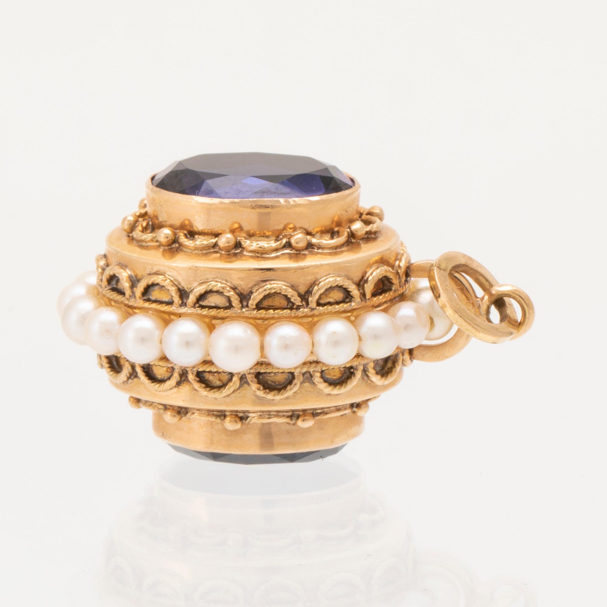 An 18K gold pendant set with synthetic colourchange purple sapphires and cultured pearls.