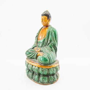 A green and yellow glazed figure of buddha, China, 20th century.