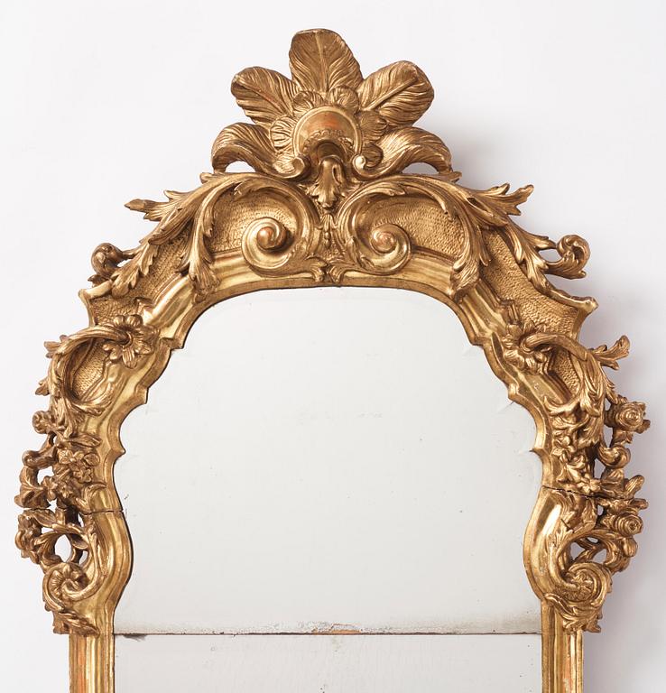 A presumably German giltwood rococo mirror, mid 18th century.