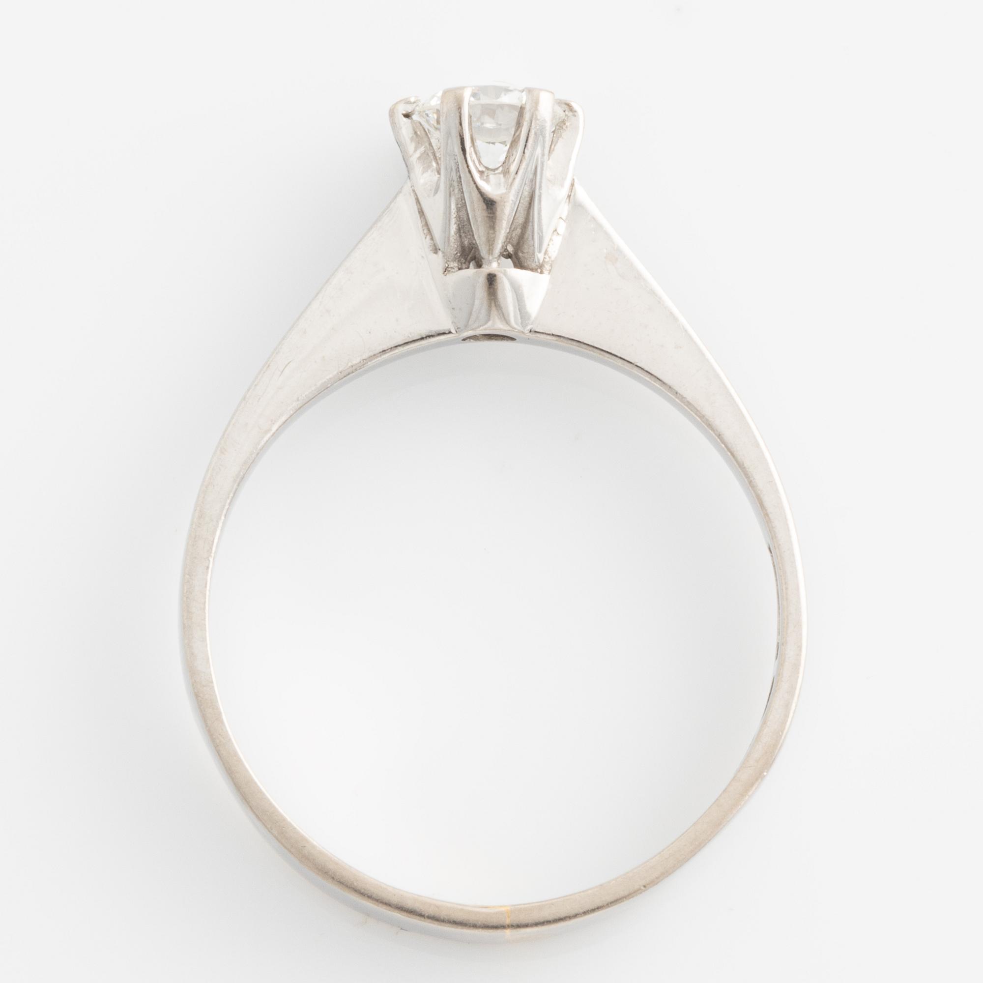 Ring solitaire with brilliant-cut diamond.