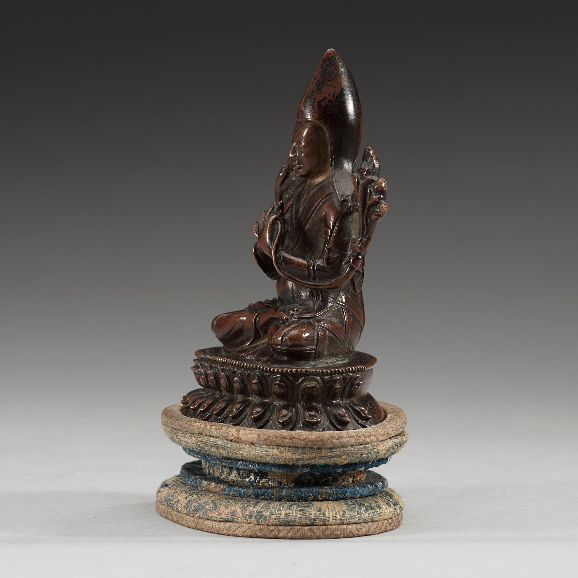 A copper alloy seated figure of a Tsong Khapa, presumably Nepal, 19th Century or older.