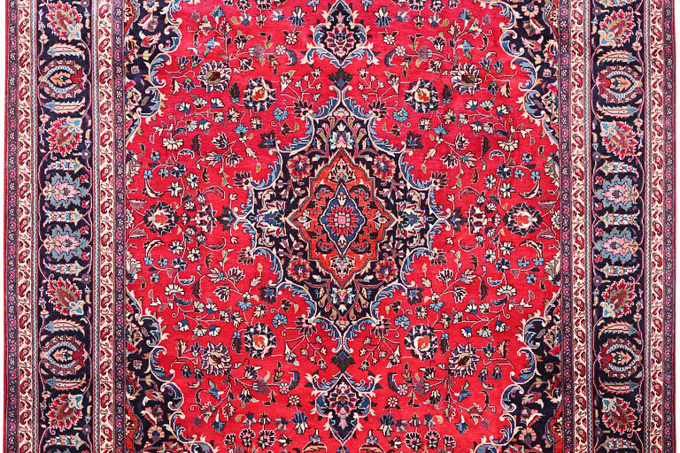 A Kashan carpet, signed, c. 358 x 244 cm.