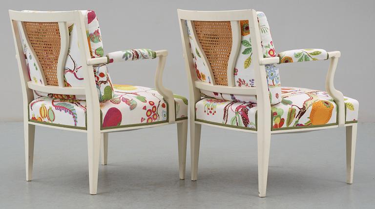 A pair of Josef Frank white lacquered and rattan armchairs by Svenskt Tenn.