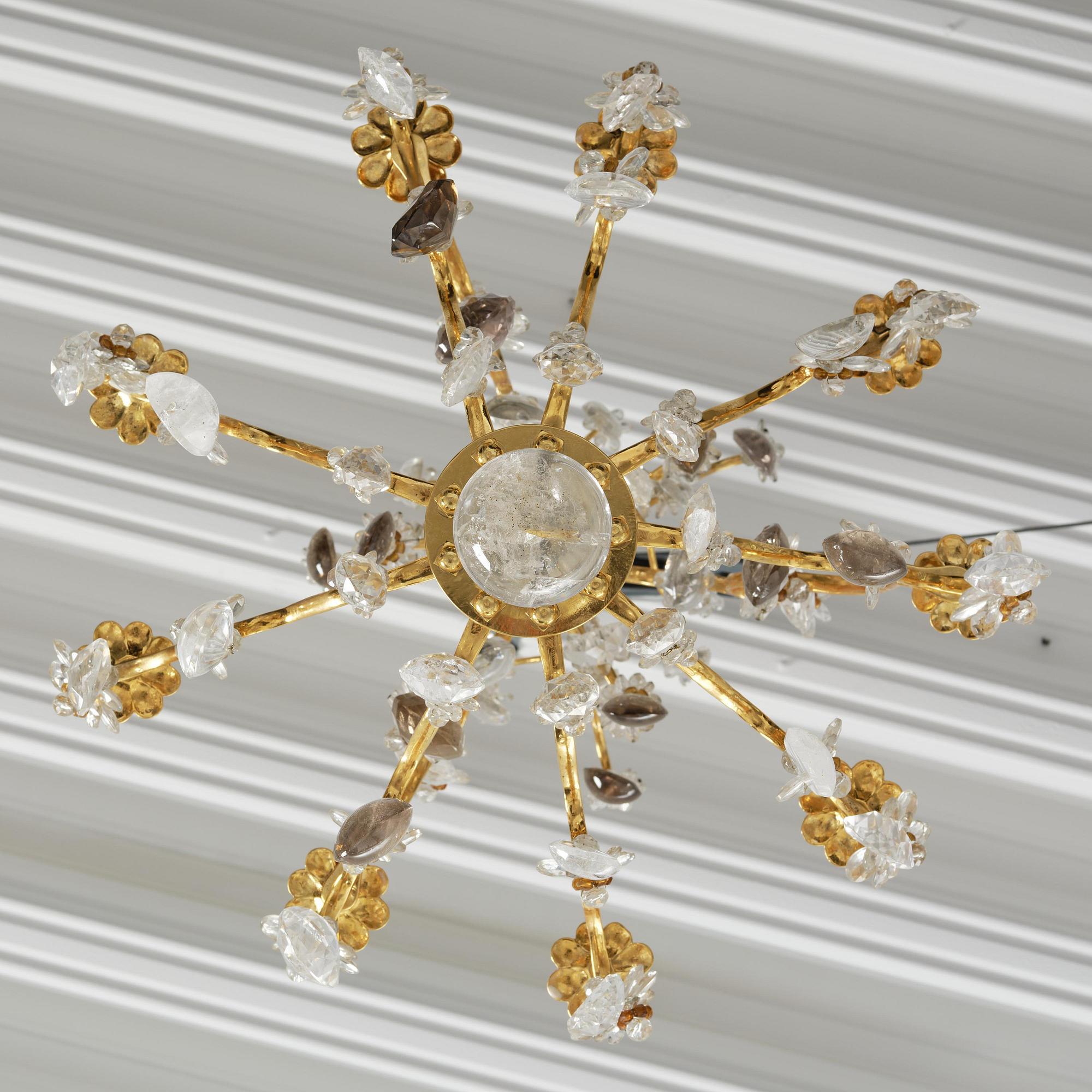 A near pair of Franch Louis-XV-style nine-branch gilt bronze and rock crystal chandeliers, later part 19th century.