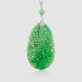 1298. A untreated carved jadeite and diamond pendant.