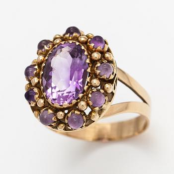 A 14K gold ring with amethysts.