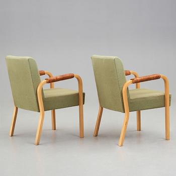 Alvar Aalto, a pair of model nr 48 laminated birch and leather easy chairs, Oy Huonekalu- ja Rakennustyötehdas for Artek, Finland.