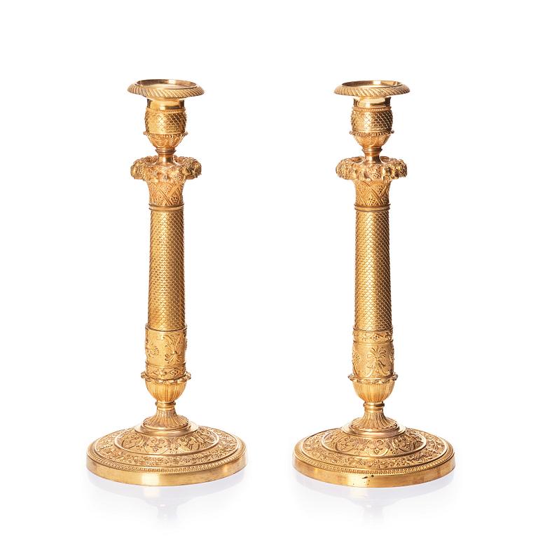 A pair of French gilded Empire candlesticks, early 19th century.