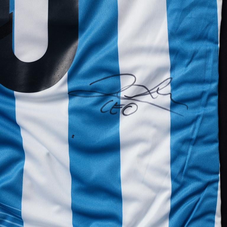 A football shirt, signed by Lionel Messi.