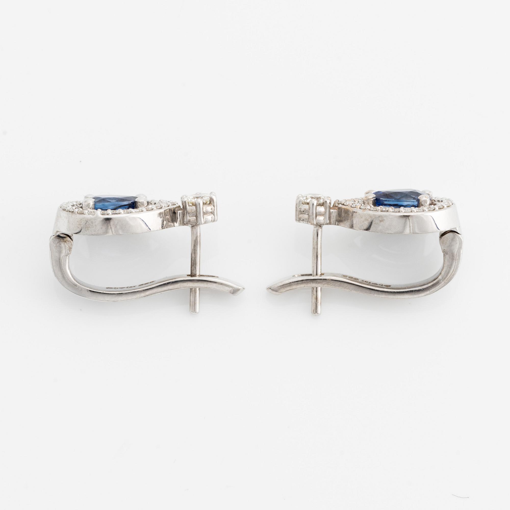 A pair of 14K gold earrings with faceted sapphires and round brilliant-cut diamonds.