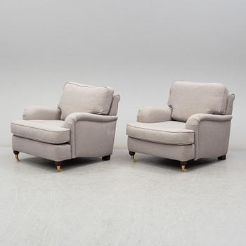 A 21st Century pair of Howard lounge chairs.