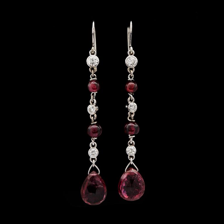 A pair of garnet and diamond earrings.