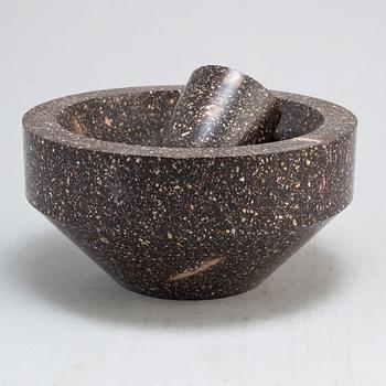 A porphyry mortar and pestle.